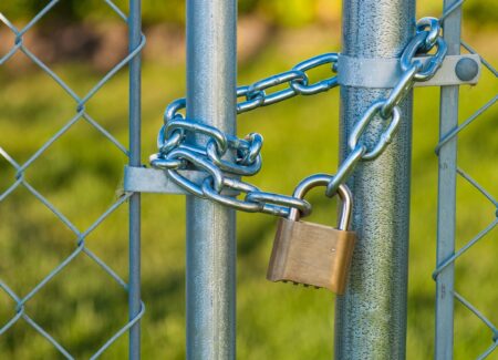 Chainlink fence with a chain and lock on it.